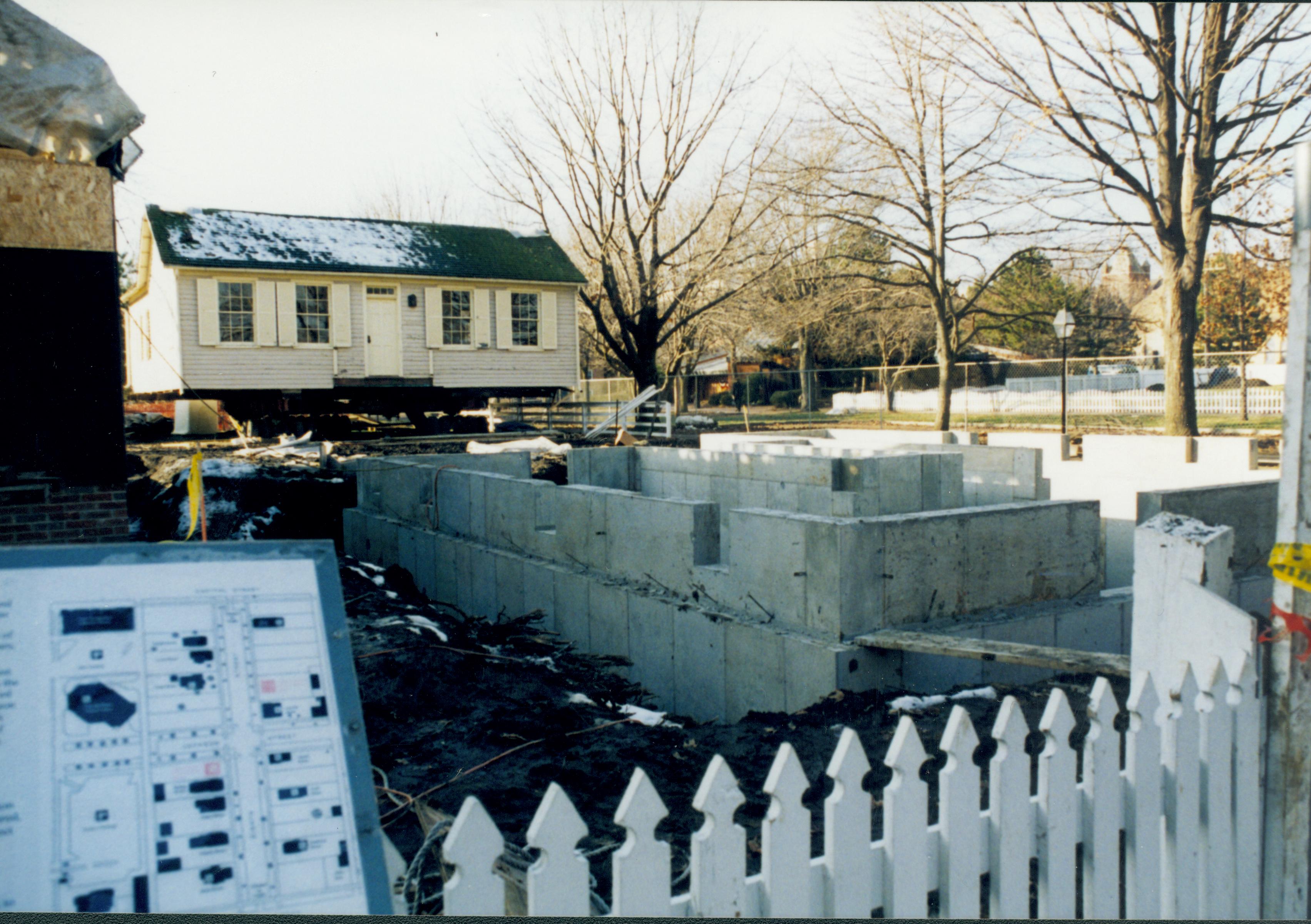 Southwest corner of foundation in foreground (photographed looking Northwest across lot). Corneau House standing in back of lot; East wall visible Lincoln Home NHS- Corneau House and Lot, Roll N5 exp 24 Corneau, move