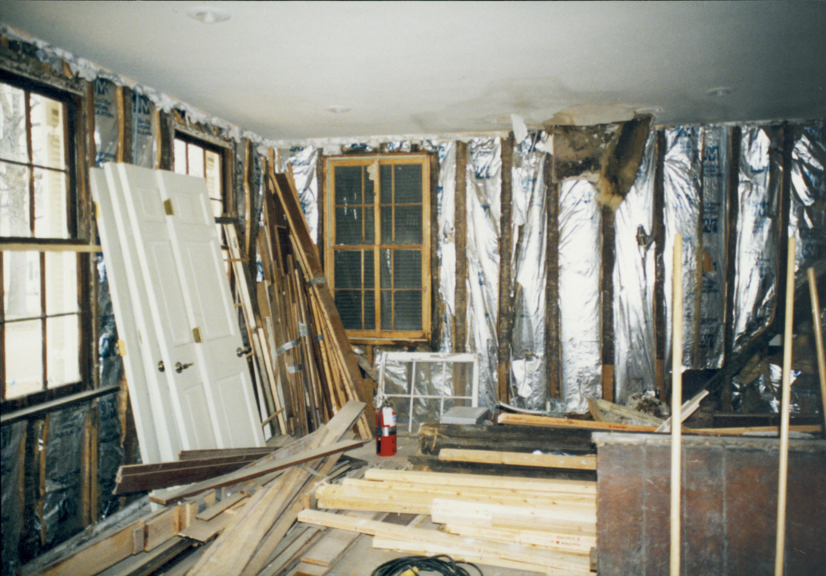 Southwall interior, Southeast corner at right of photo (under all that wood). 2 windows on East wall. Photo taken while standing in exactly the same location at number 21 Lincoln Home NHS- Corneau House Restoration, roll N4 exp 22 Corneau House, restoration