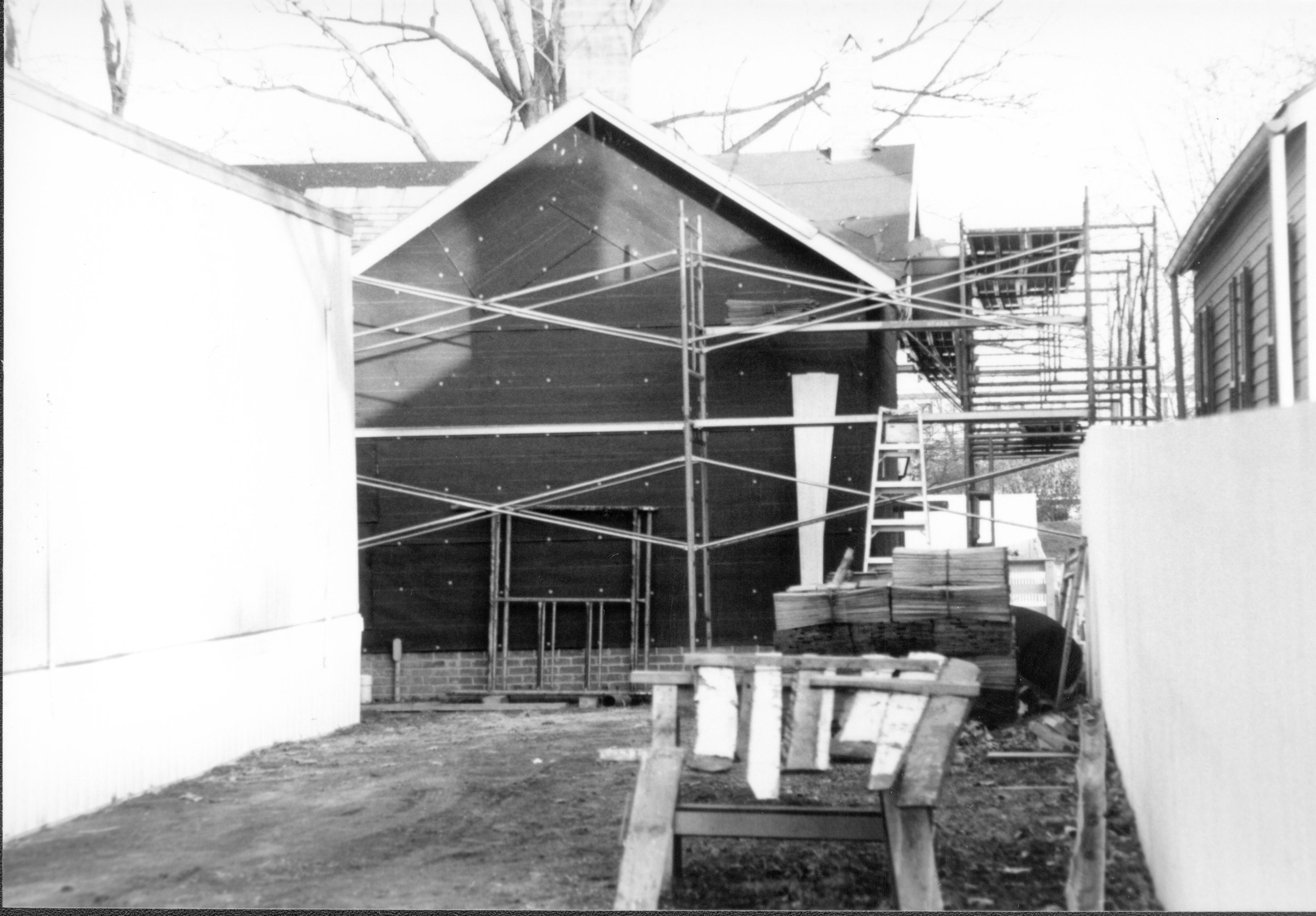 Corneau - restoration, scaffolding installed on South and West elevations. Temporary restroom building in foreground left. Sprigg House on right on other side of fence. Looking East from Corneau Lot (Block 6, Lot 16) Corneau, restoration, scaffolding, temporary, restroom, Sprigg