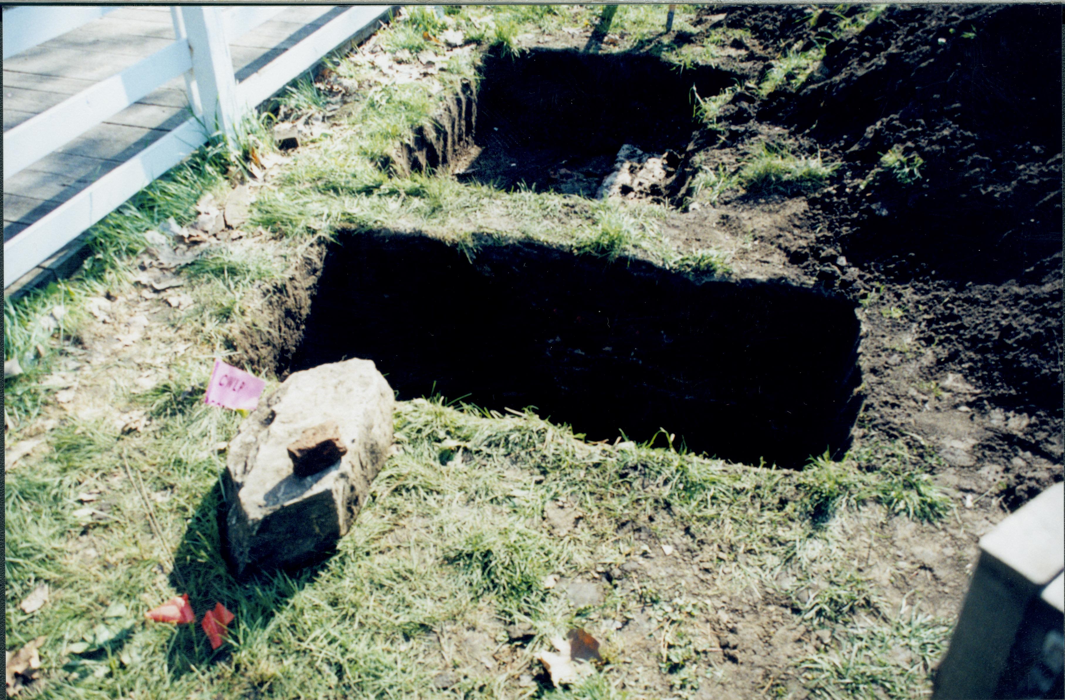 Uncovered foundation while searching for 1880s barn. apperas to be associated with later structure. Photo taken looking East along North side of property line Lincoln Home NHS- Corneau House Restoration, roll N6 exp 20 Corneau House, restoration