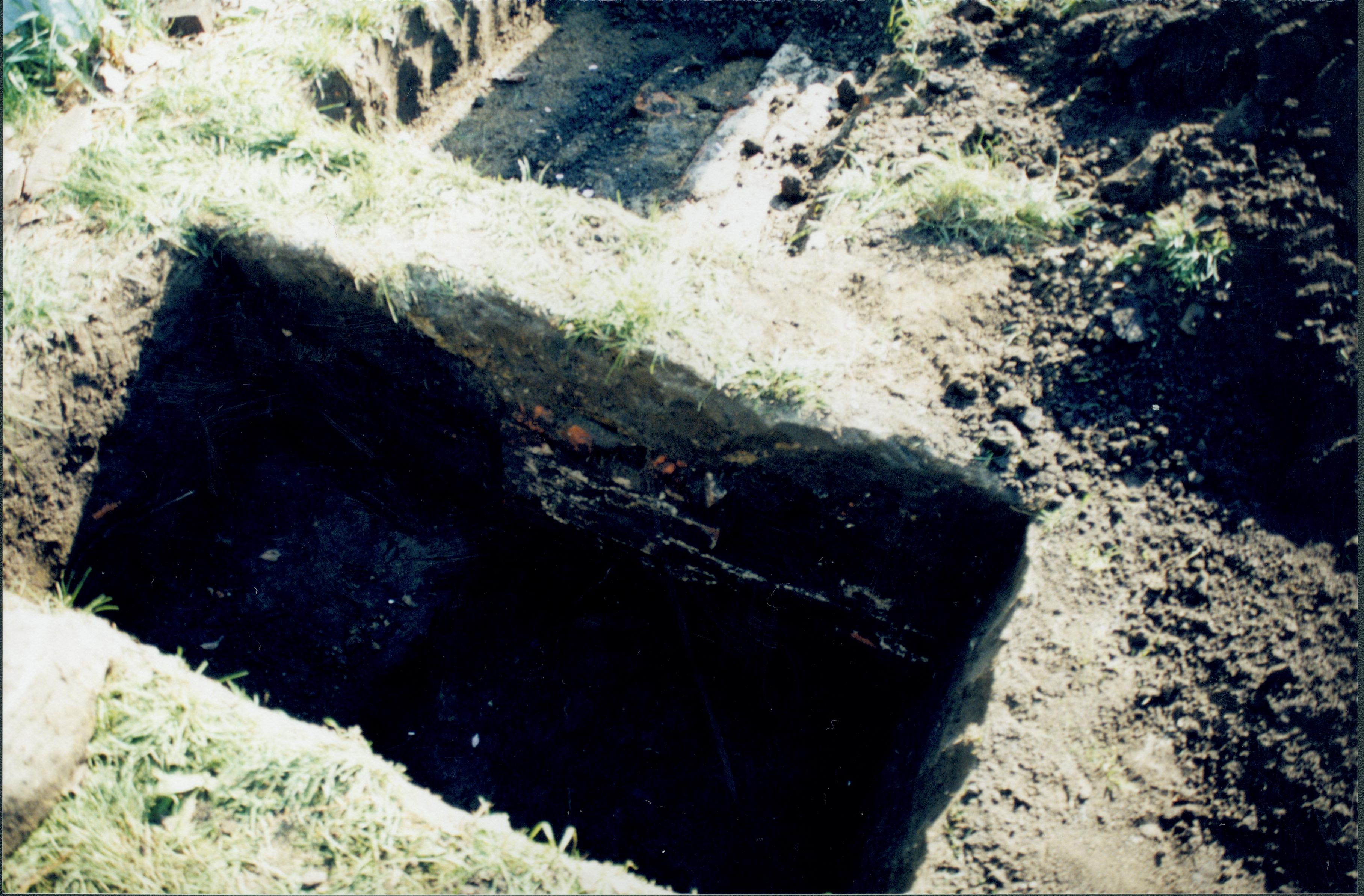 Uncovered foundation while searching for 1880s barn. apperas to be associated with later structure. Photo taken looking East along North side of property line Lincoln Home NHS- Corneau House Restoration, roll N6 exp 21 Corneau House, restoration