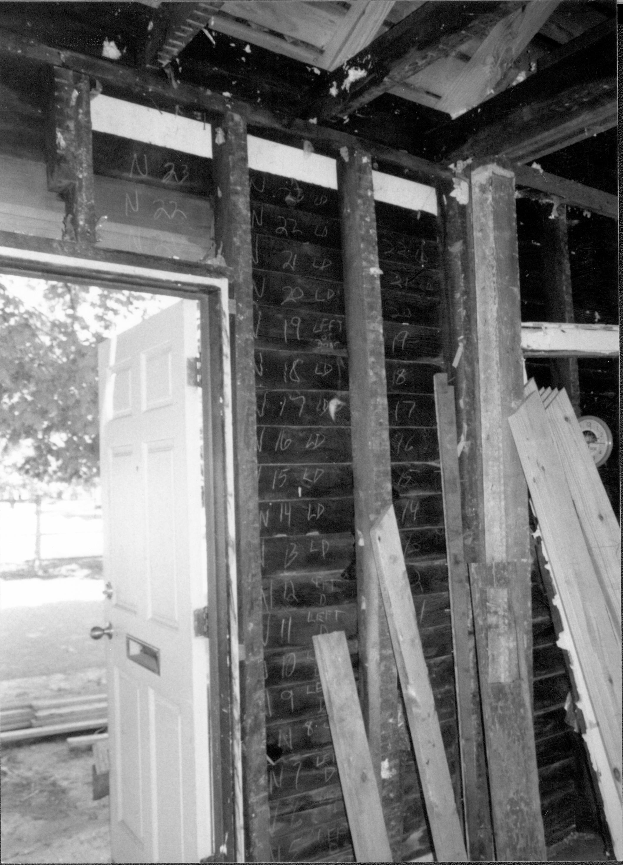 Siding on inside of North wall is numbered before removal and preparation for reinstallation. Shows East side of North wall (door at left) Lincoln Home NHS- Corneau House Restoration, roll N12 exp 10 Corneau House, excavation