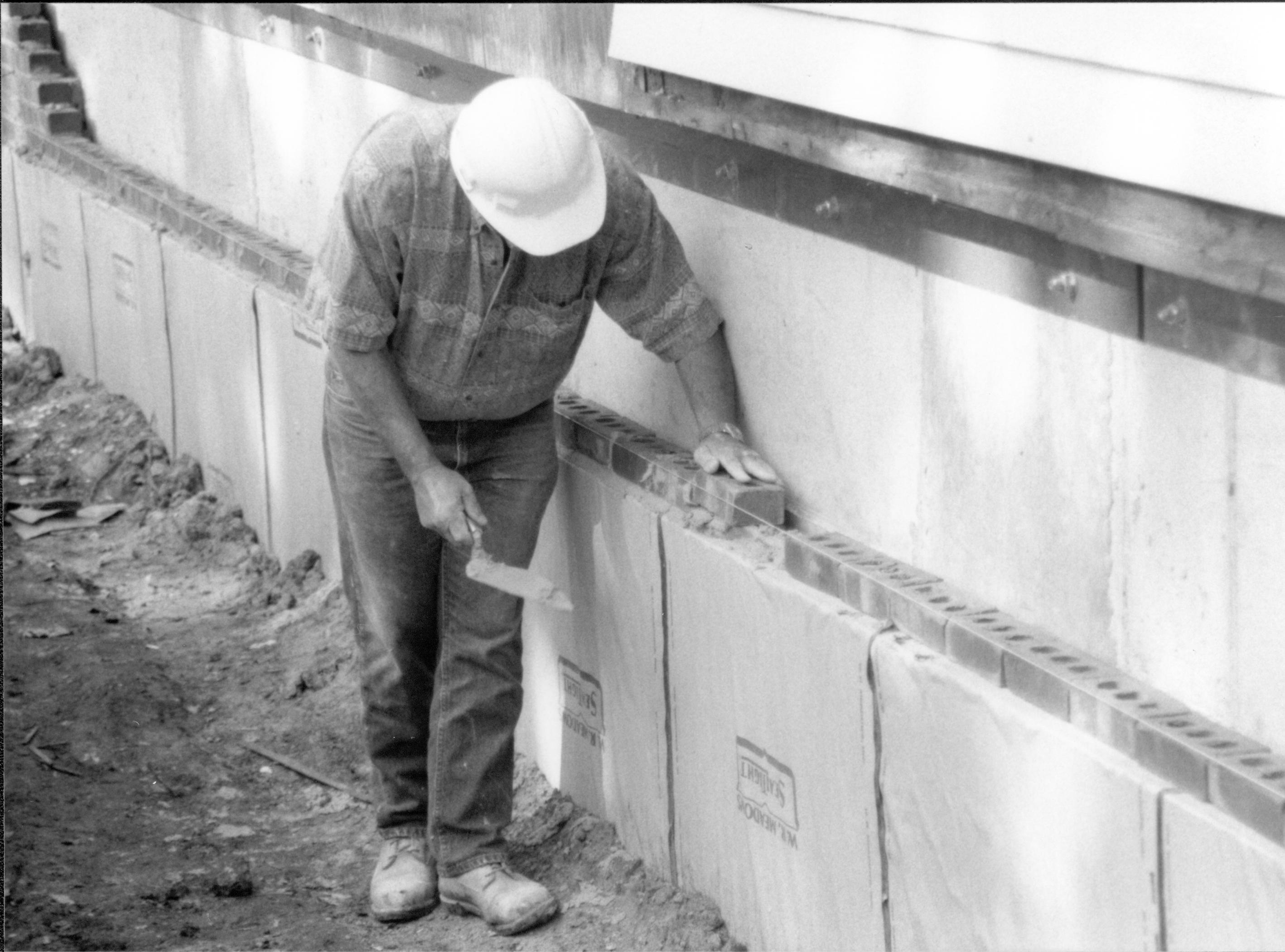 Details of bricks being laid around foundation. Photo taken at Northeast corner of house, looking South along East wall Lincoln Home NHS- Corneau House Restoration, roll N12 exp 19 Corneau House, excavation