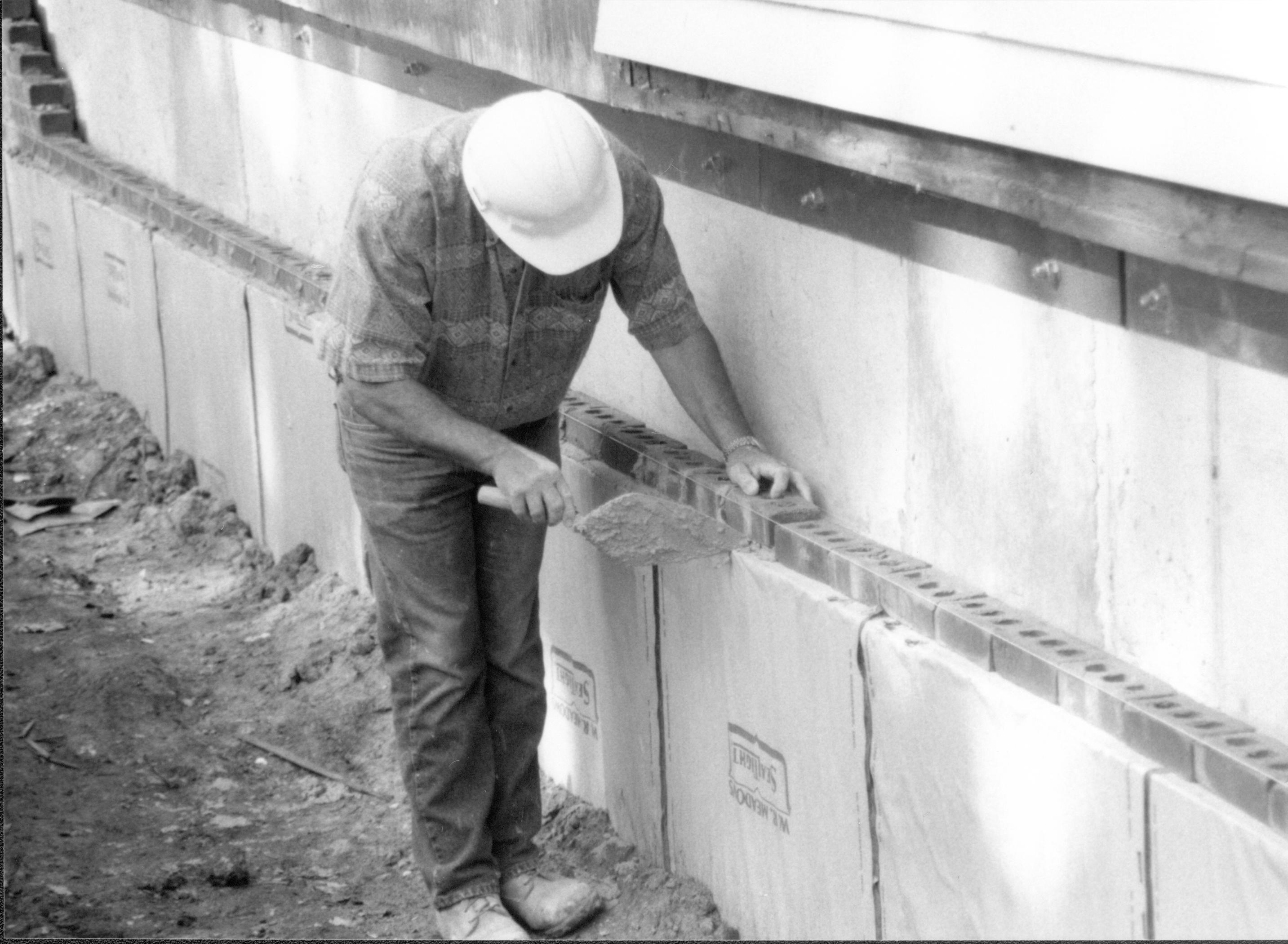 Details of bricks being laid around foundation. Photo taken at Northeast corner of house, looking South along East wall Lincoln Home NHS- Corneau House Restoration, roll N12 exp 20 Corneau House, excavation