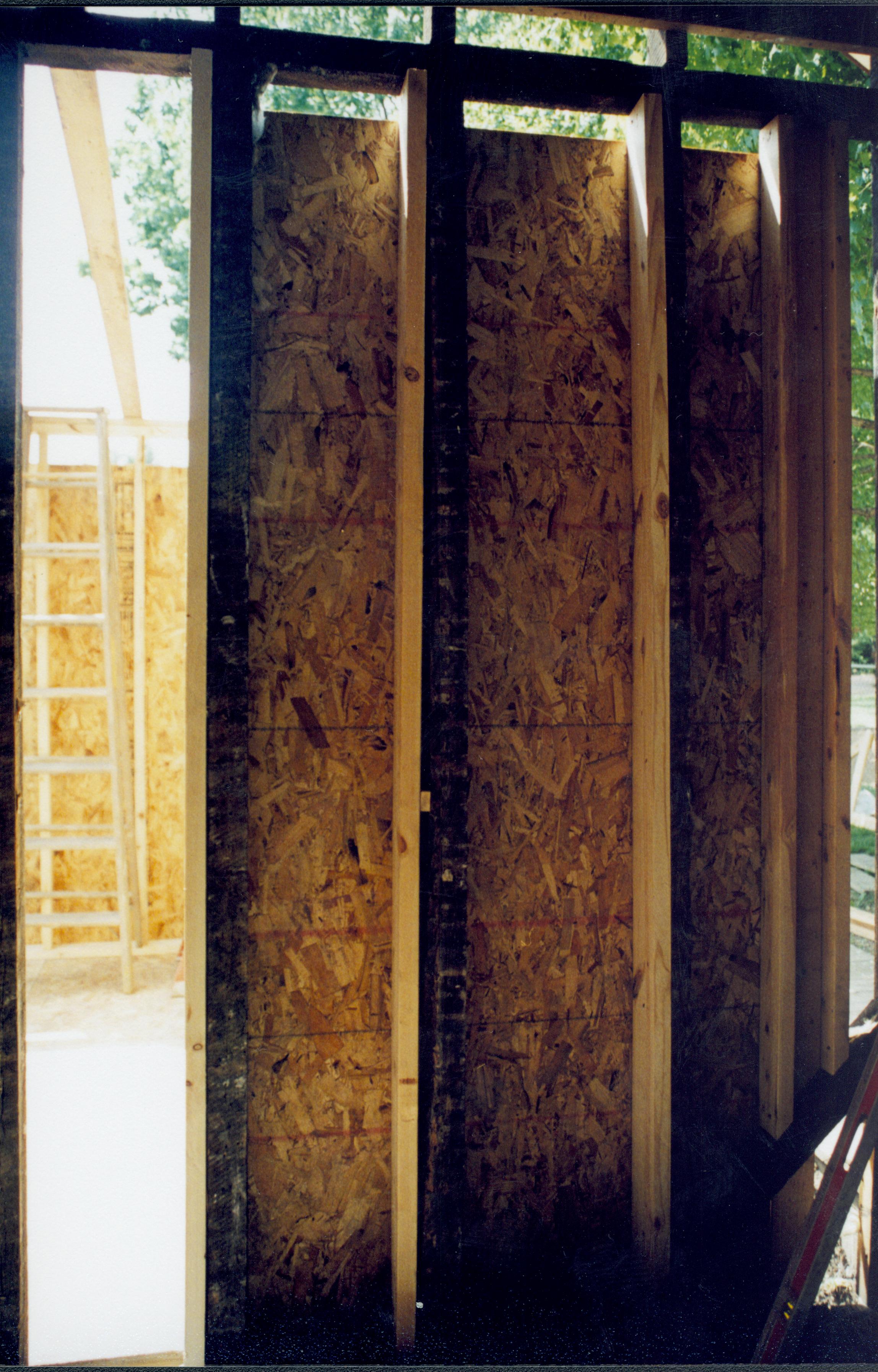 Looking West from room 104, ito room 105 (East wall in foreground). Wall studs and plywood in place. Photo taken facing West Lincoln Home NHS- Corneau House Restoration, roll N8 exp 17 Corneau House, renovation