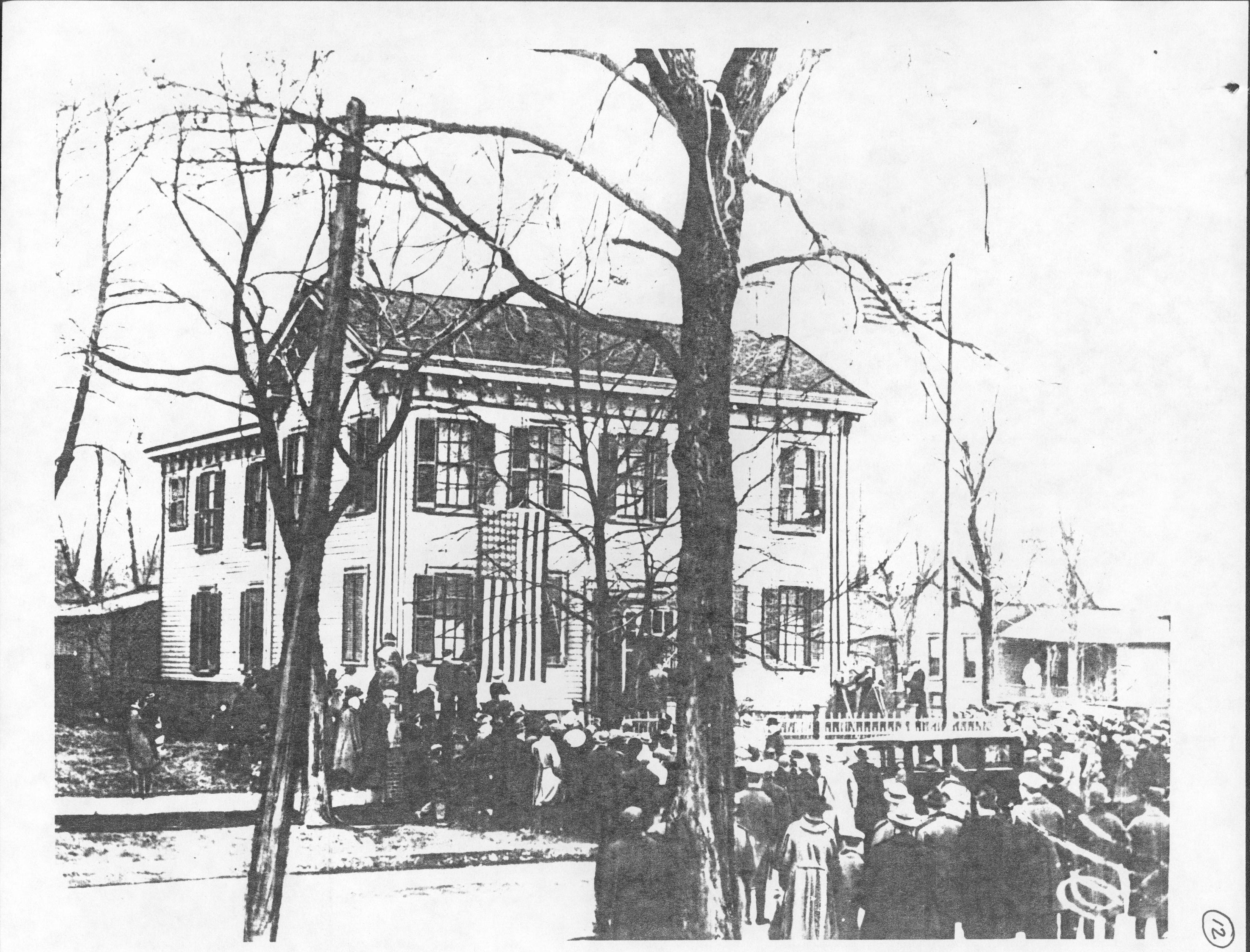 View of Lincoln Home with Arnold House in background; taken at 1919 celebration. Appears to show off-set on west side, see roof configuration (Only photos of pre-1900 Arnold House exist in background of Lincoln Home photos) LIHO NHS- Arnold House, #12 Arnold House, Lincoln Home