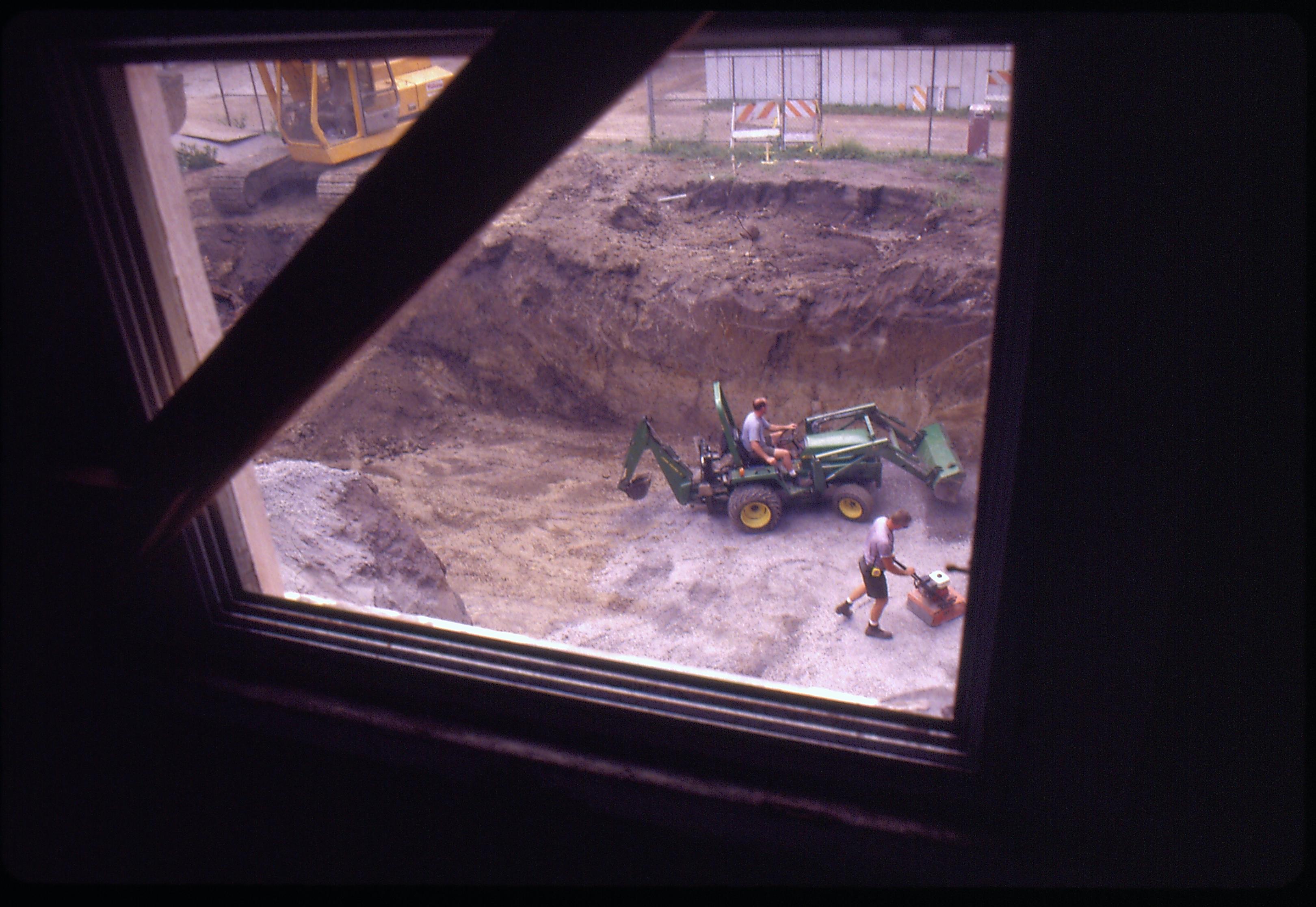 Morse - basement excavation with Maintenance workers Al McHenry (on backhoe) and Ed Smith spread and compress gravel in basement in preparation for concrete pour. Looking West from second floor of pre-restoration Morse House Morse, foundation, excavation, staff, pre-restoration