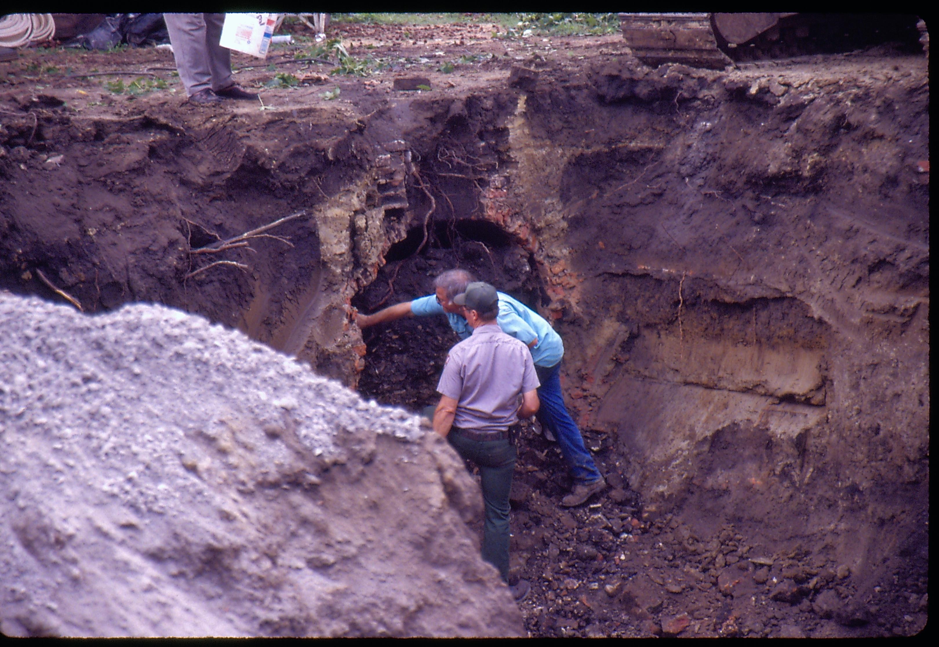 Morse - basement excavation with Cistern excavation. Fever River Archeologist Floyd Mansberger points out the side wall of cistern to Maintenance Worker Vee Pollack. Historian Tim Townsend? stands on edge of pit. Looking Southwest from Morse Lot (Block 10, Lots 15-16) Morse, foundation, cistern, archeology, staff, Fever River