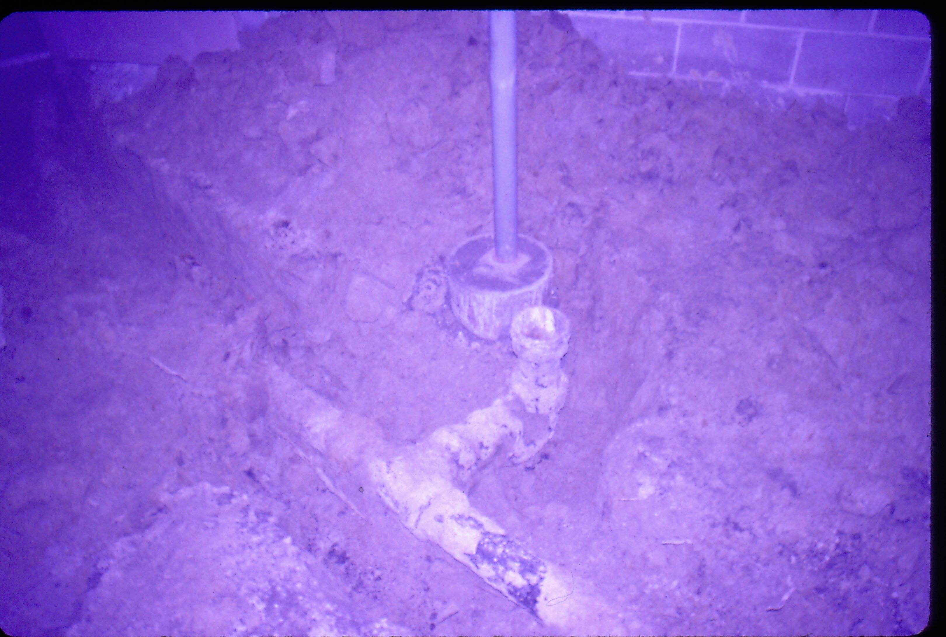 Lyon House - basement, footings and pipes in furnace room under removed floor. Cinder block wall visible in background Looking North in furnace room in basement Lyon, Basement, pipes, plumbing, cinder block, footings