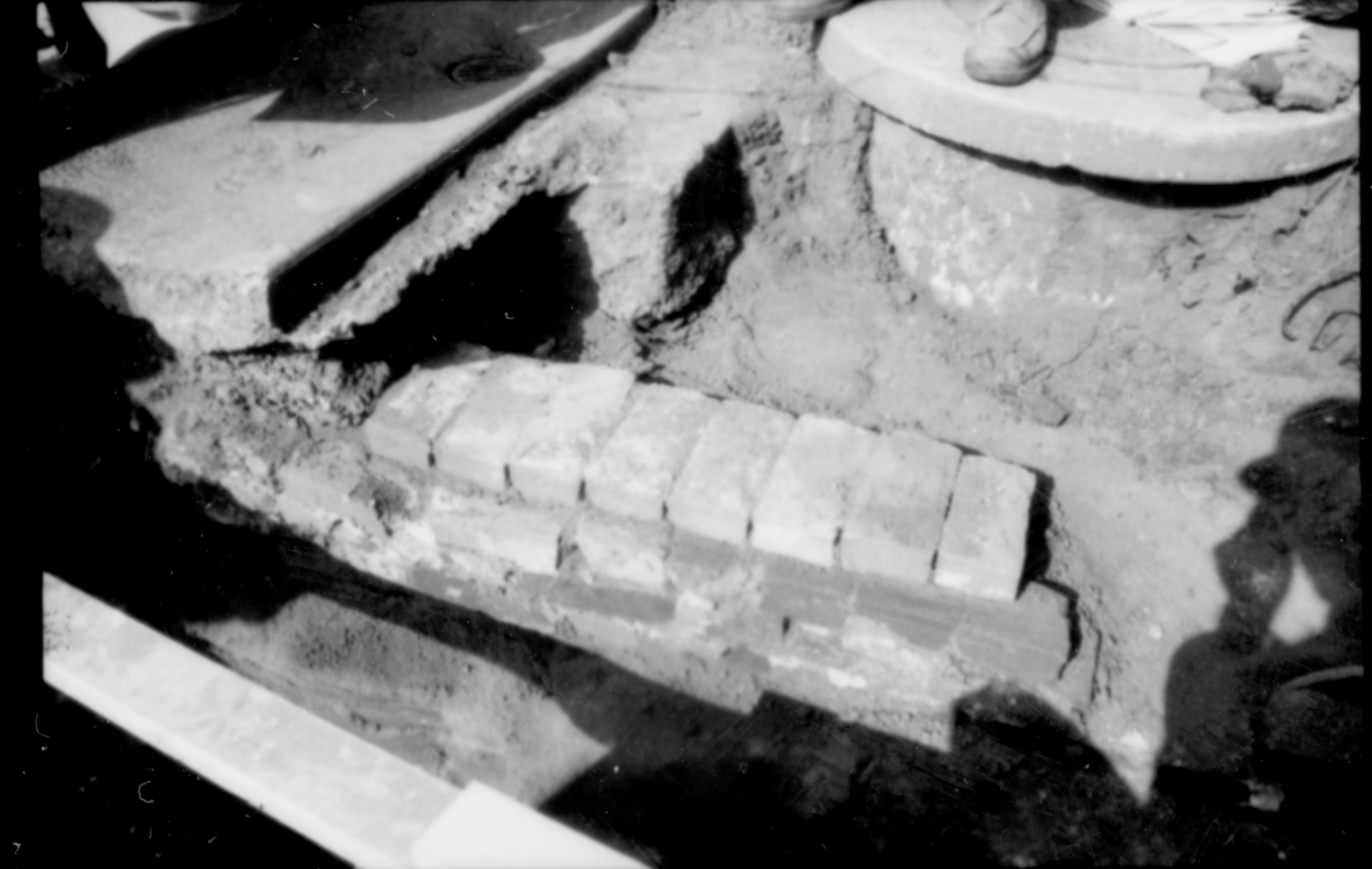 A section of brick near the south west corner of the Lincoln Home. A sewer drain sits to the upper right of the photograph, with concrete drain to the left. Photographer facing north east. See photo 61847 for reference.