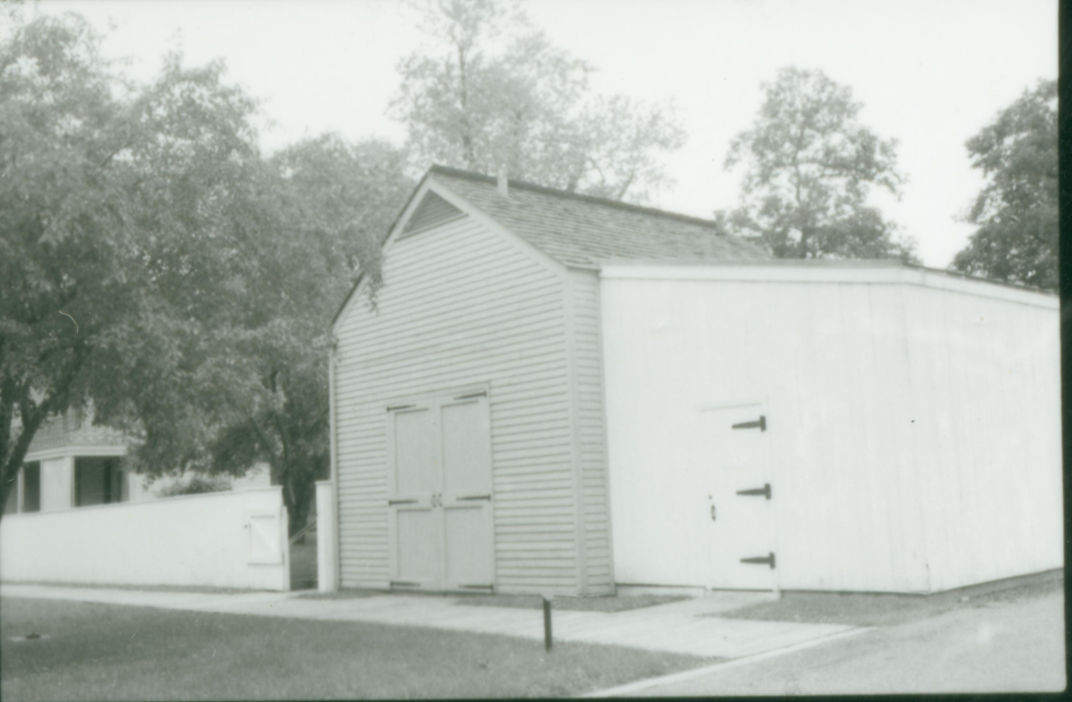 Lincoln Home carriage house and woodshed, with the Lincoln Home in the background. Photographer facing north west.