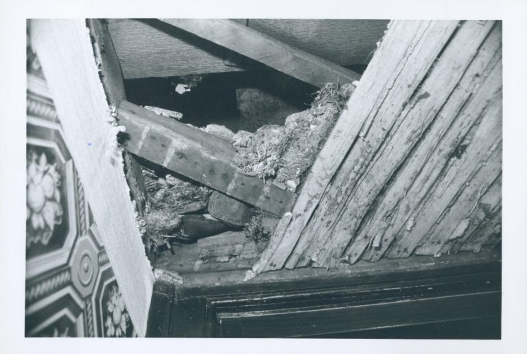 Framing and lath under the front (west) stairwell of the Lincoln Home, revealed during the 1987-1988 Restoration. Note the frame to the Dining Room/Front Hall doorway at bottom of photograph. Photographer facing east.