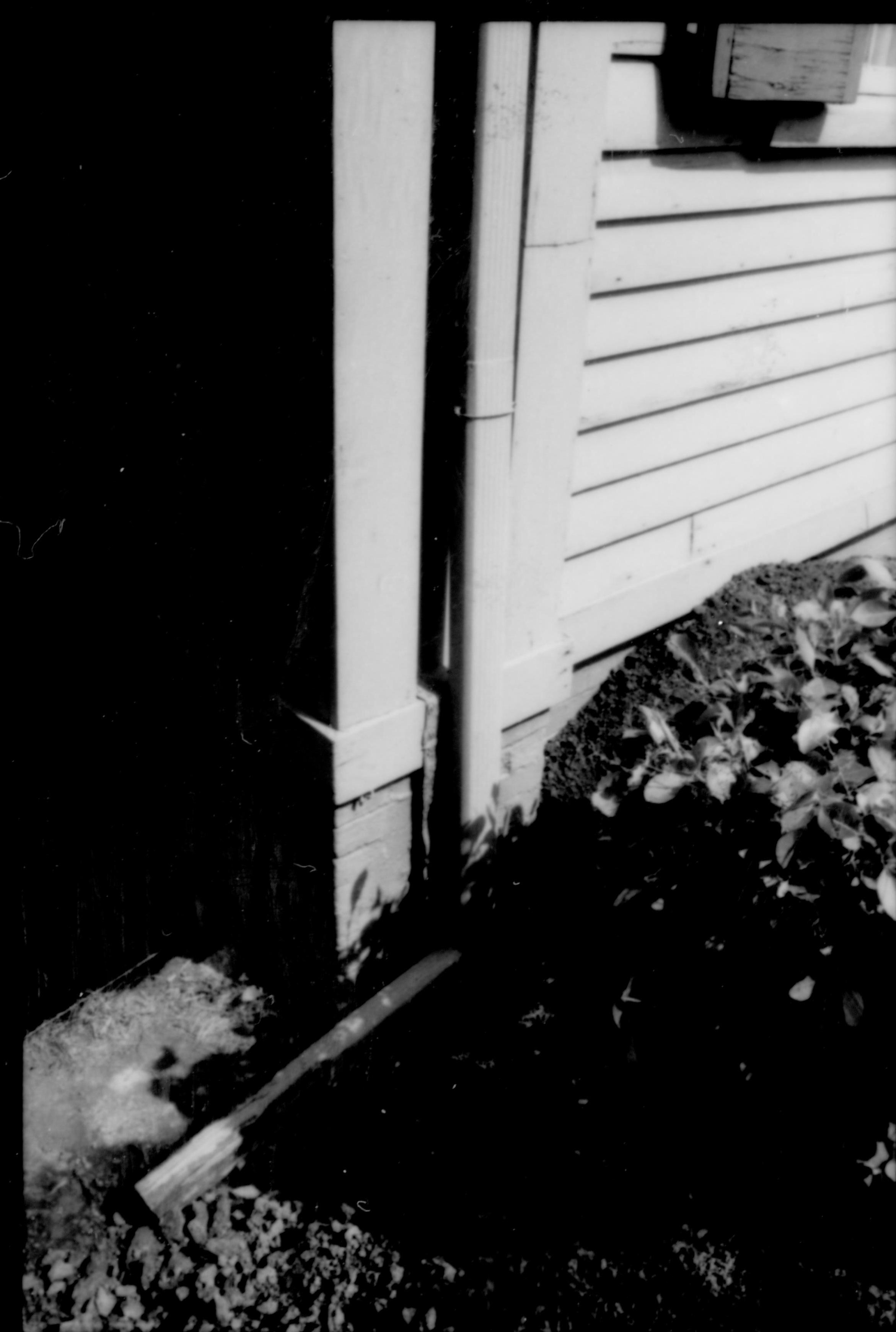 Square base pillar on northwest corner of Lincoln Home, with drain and waterboards. Photographer facing south east.