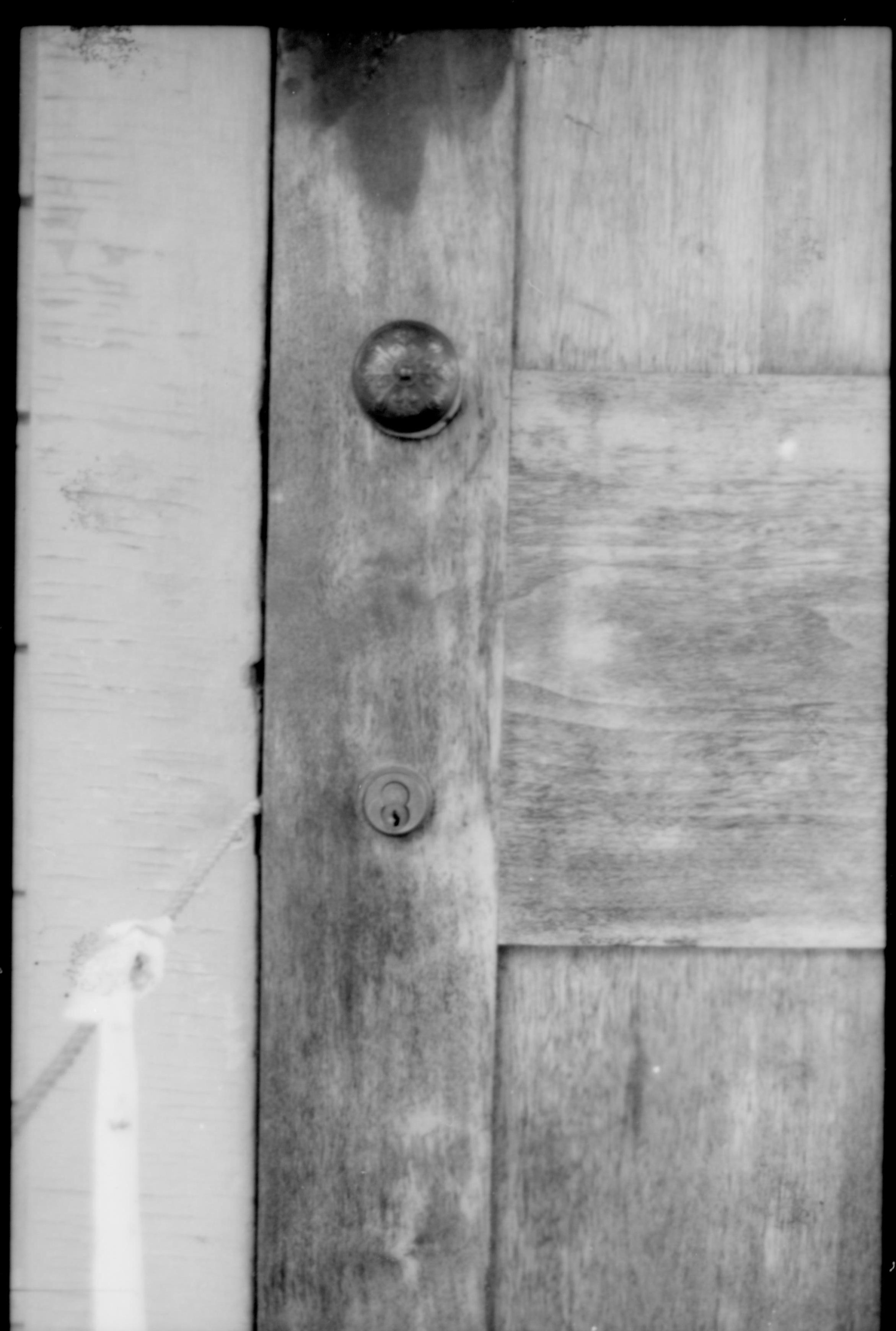 A close up picture of a doorknob and keyhole.