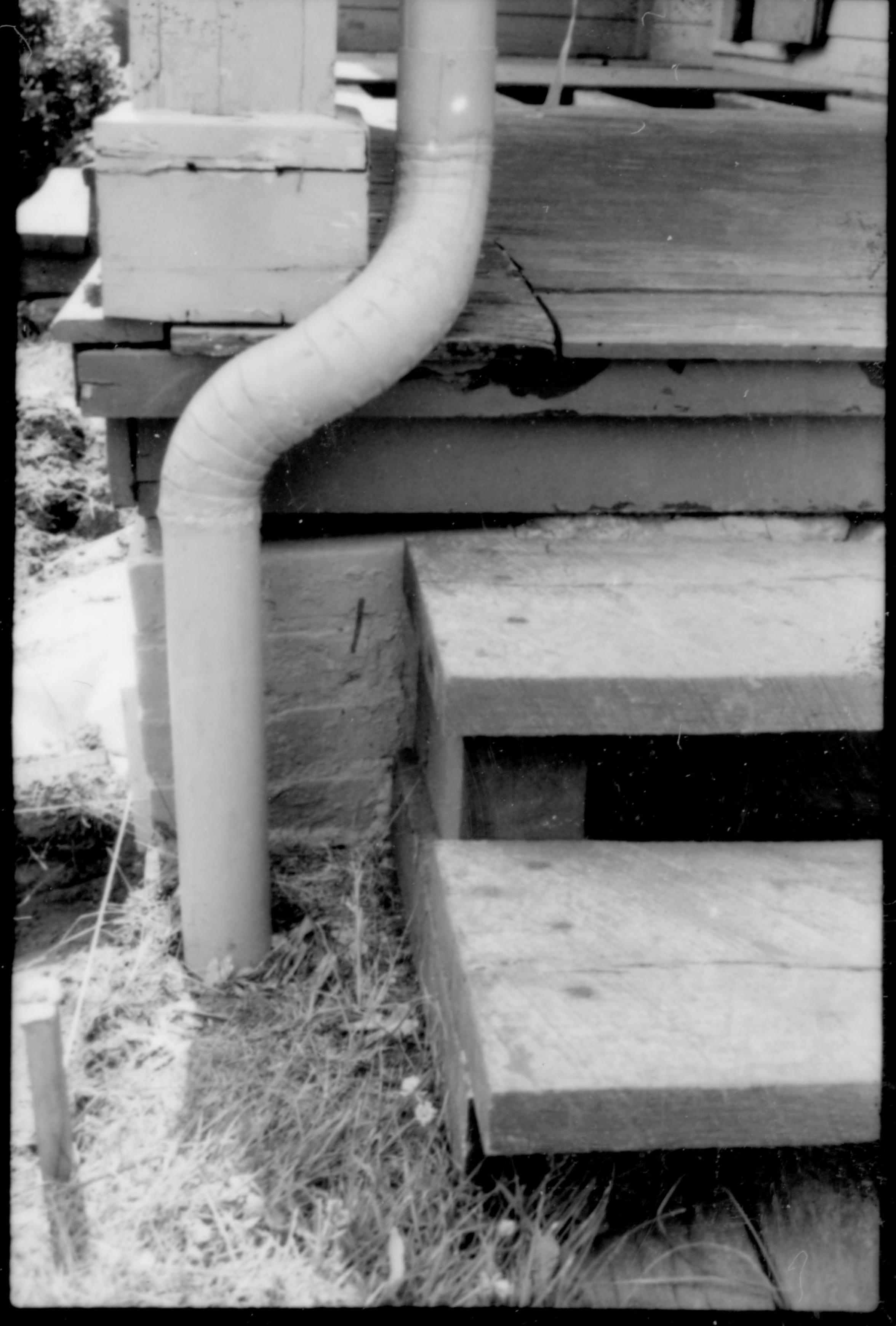 Drain pipe on the south east corner of the Lincoln Home, near the south porch. Photo is prior to or during the Lincoln Home restoration of 1987-88. Photographer facing west.