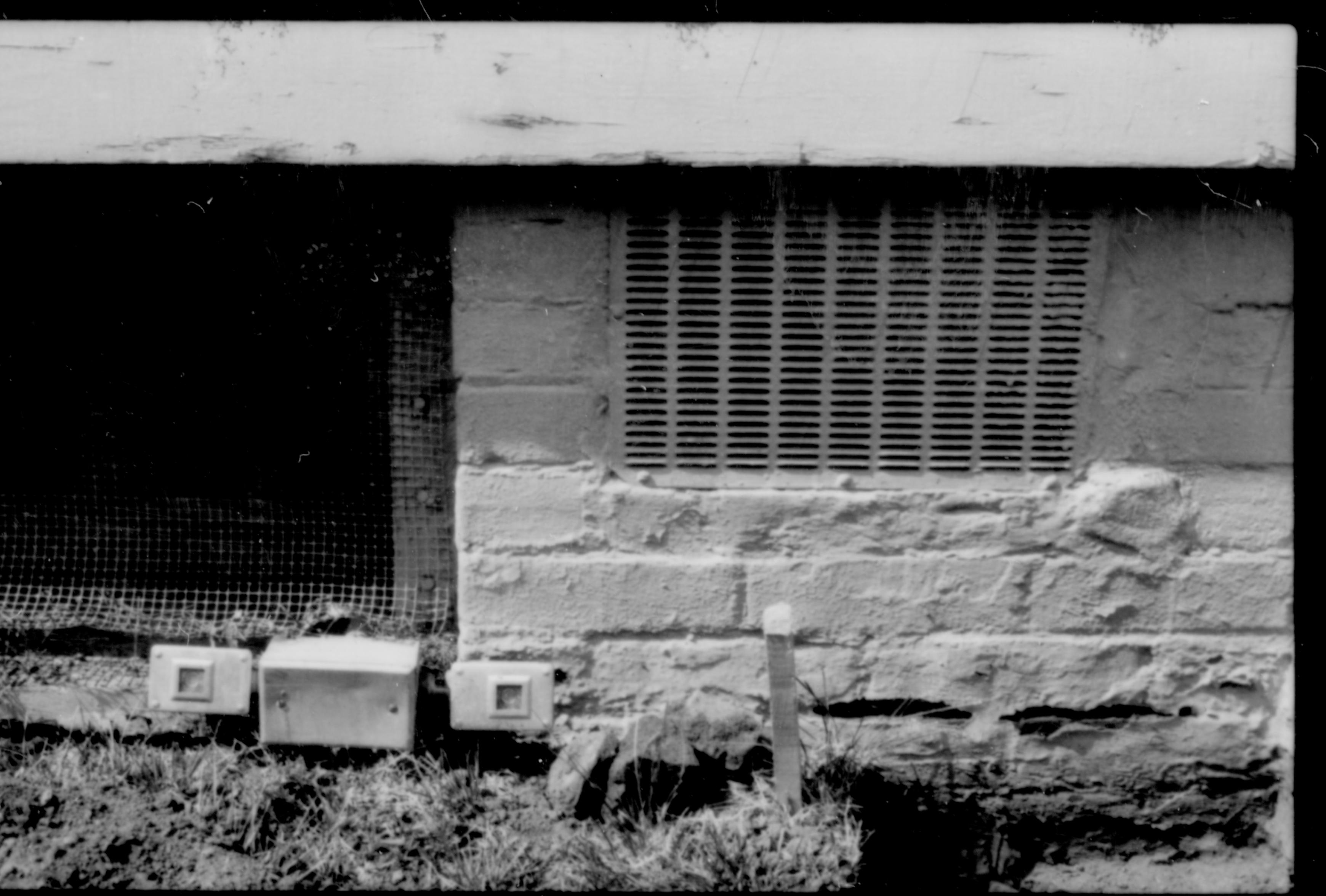 A vent and window space for the basement along the south side of the Lincoln Home. The vent was bricked up, and the window replaced, during the 1987-88 restoration. Photographer facing north.