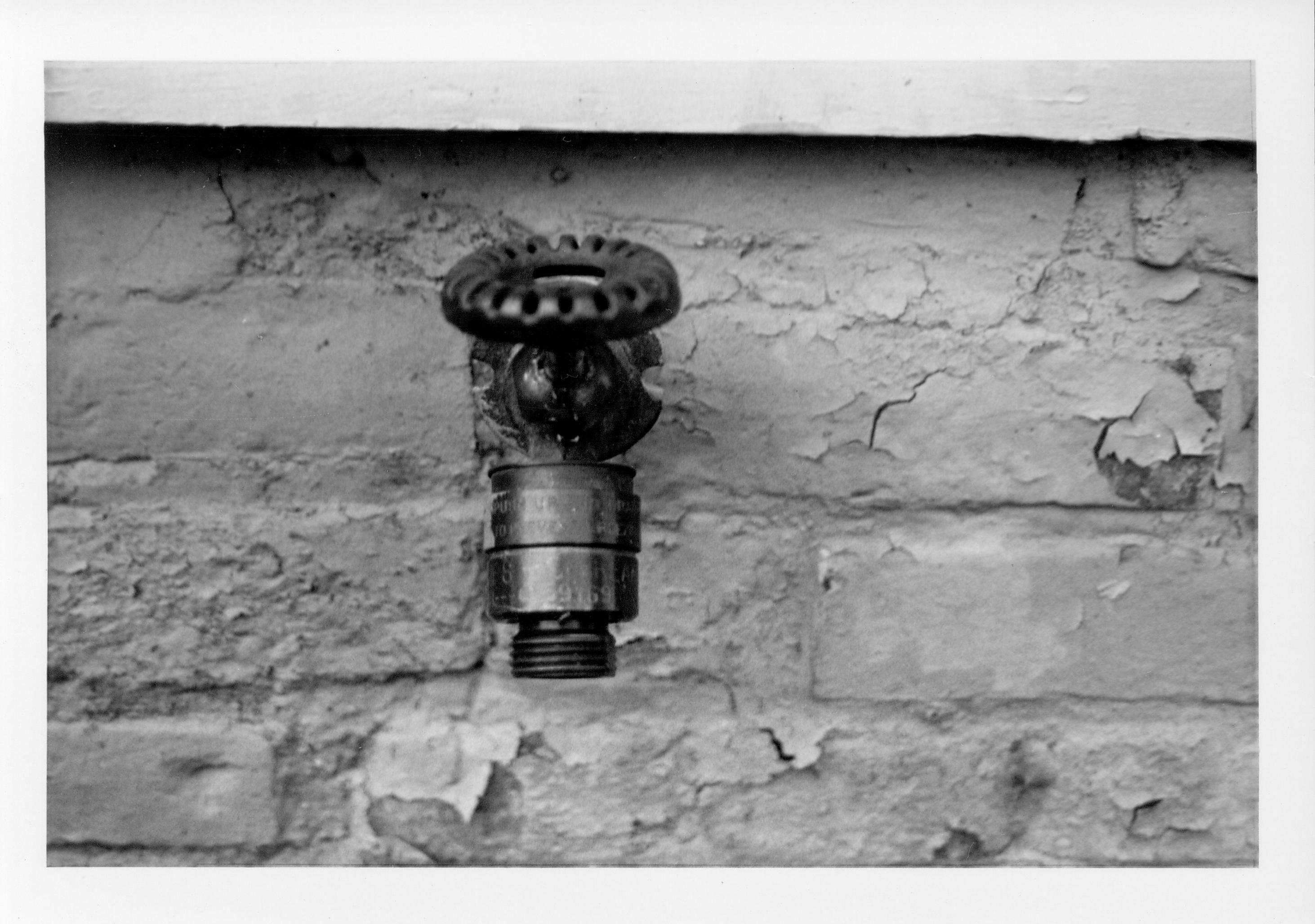 A water spigot, probably located on north side of the Lincoln Home foundation.