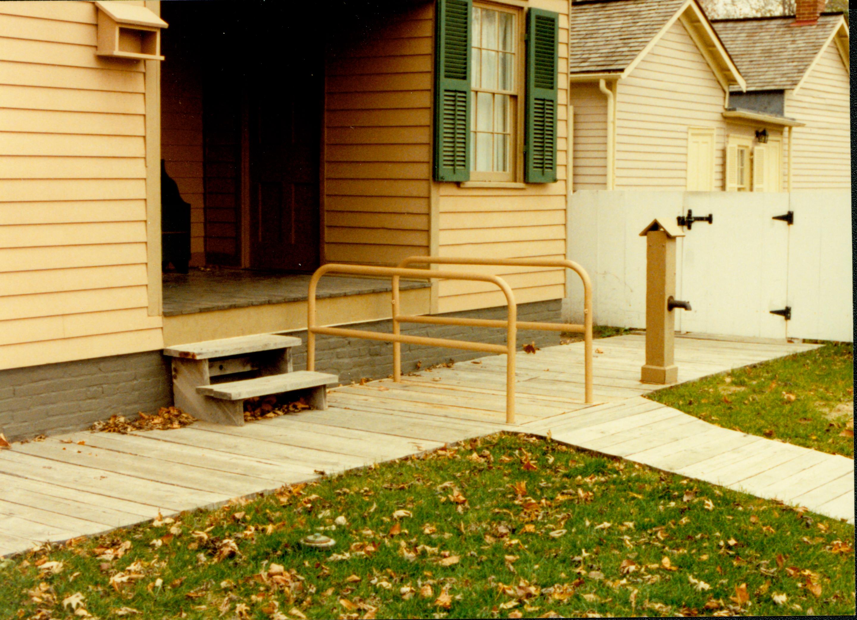 Lincoln Home wheelchair lift, fully retracted. Corneau house in background. Photographer facing north west.