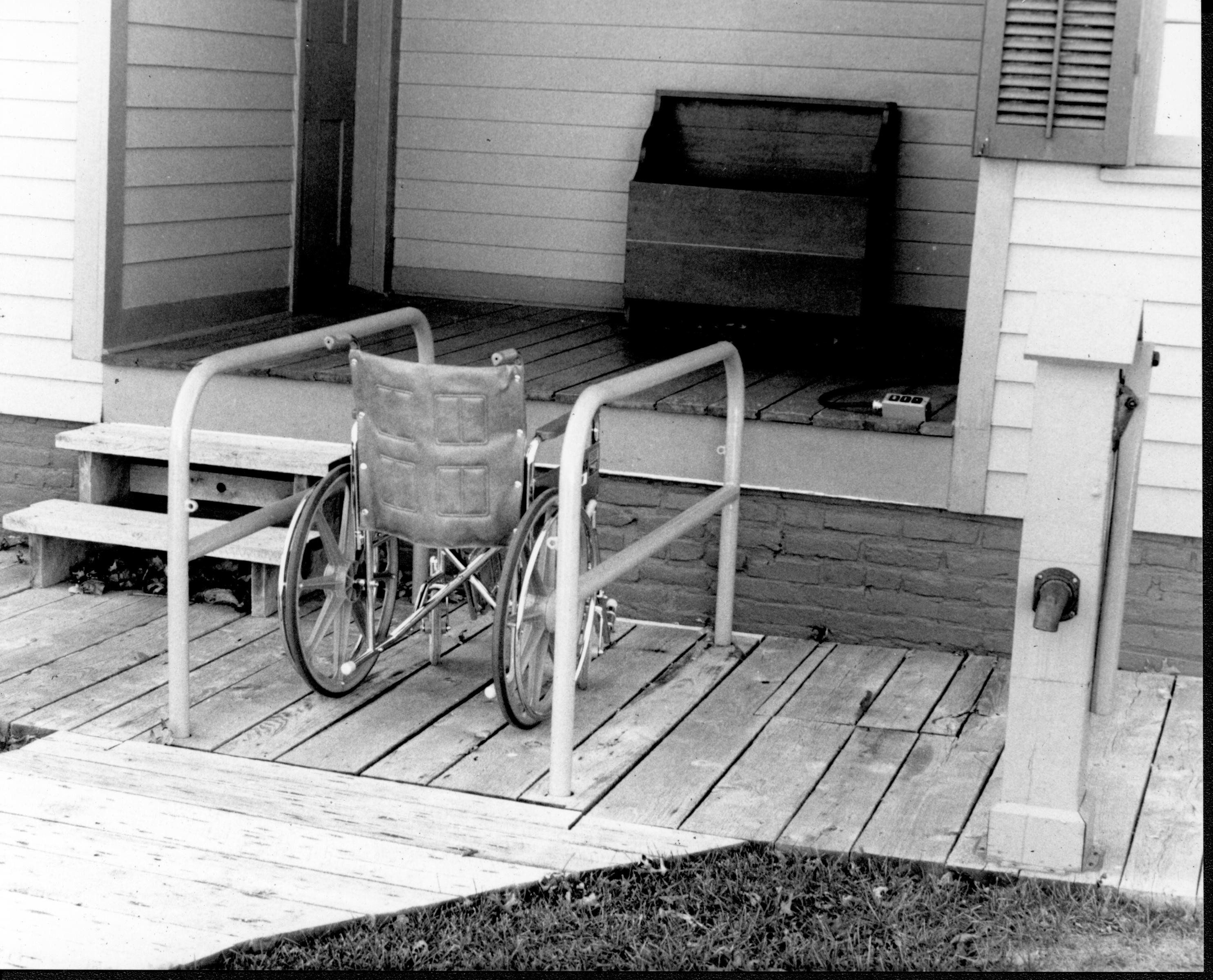 Lincoln Home wheelchair lift, fully retracted, with empty wheelchair. Photographer facing southlincoln west.