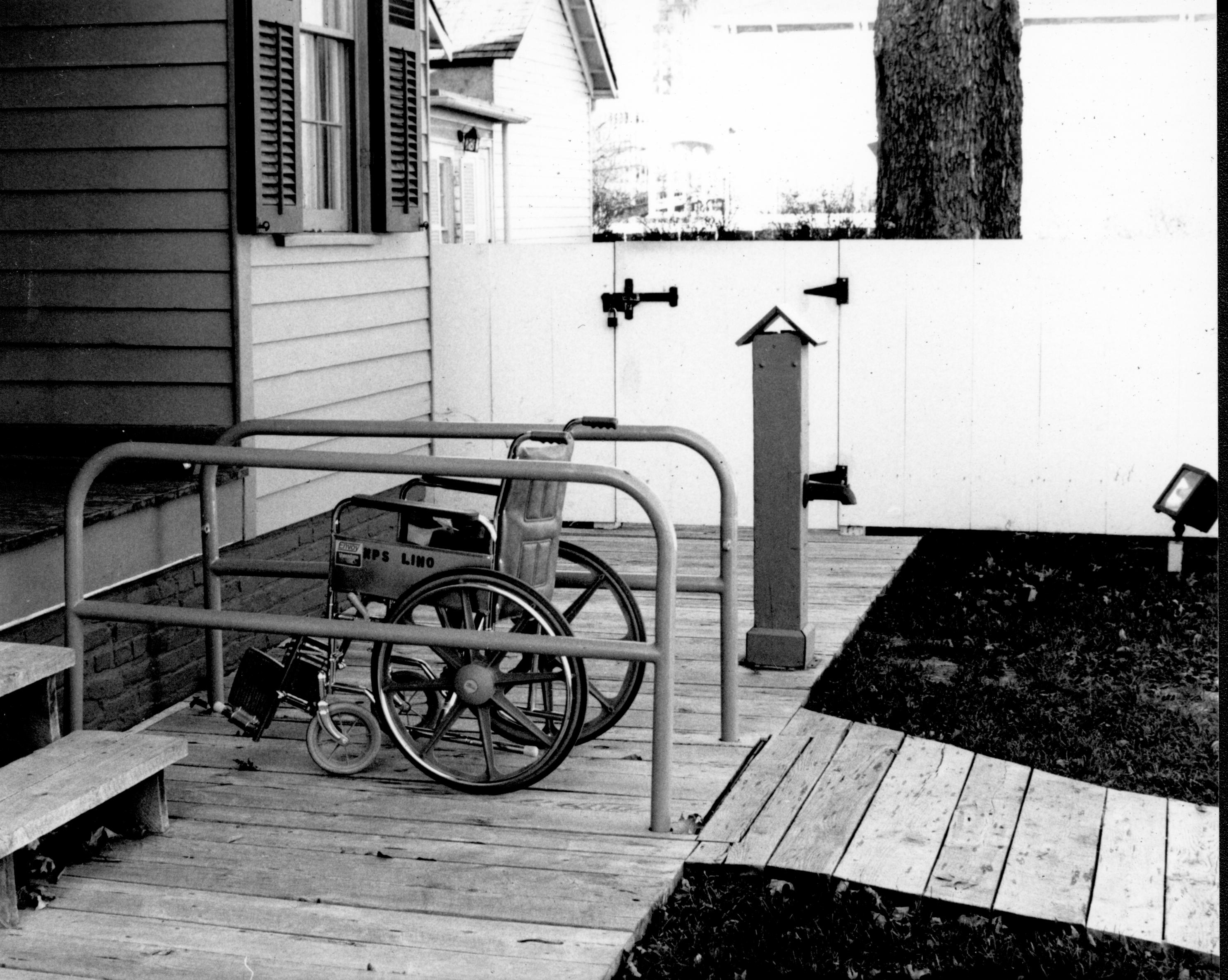 Lincoln Home wheelchair lift, fully retracted, with empty wheelchair. Photographer facing north west.
