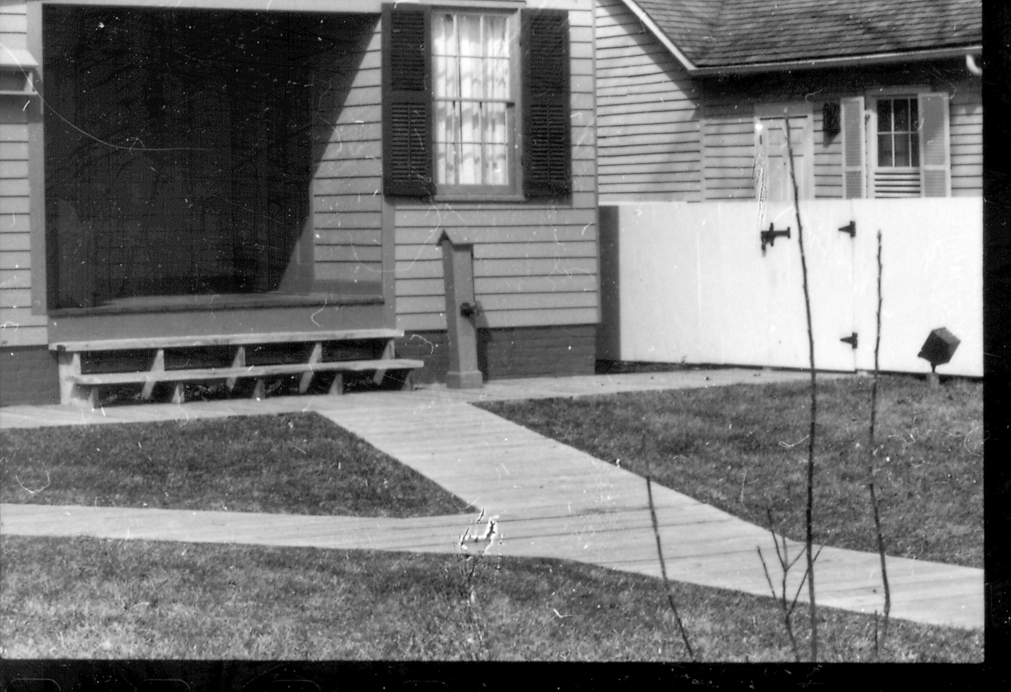 View of the East Porch and boardwalk of the Lincoln Home prior to the addition of the wheelchair lift. Corenau house in the background. Photographer facing north west.