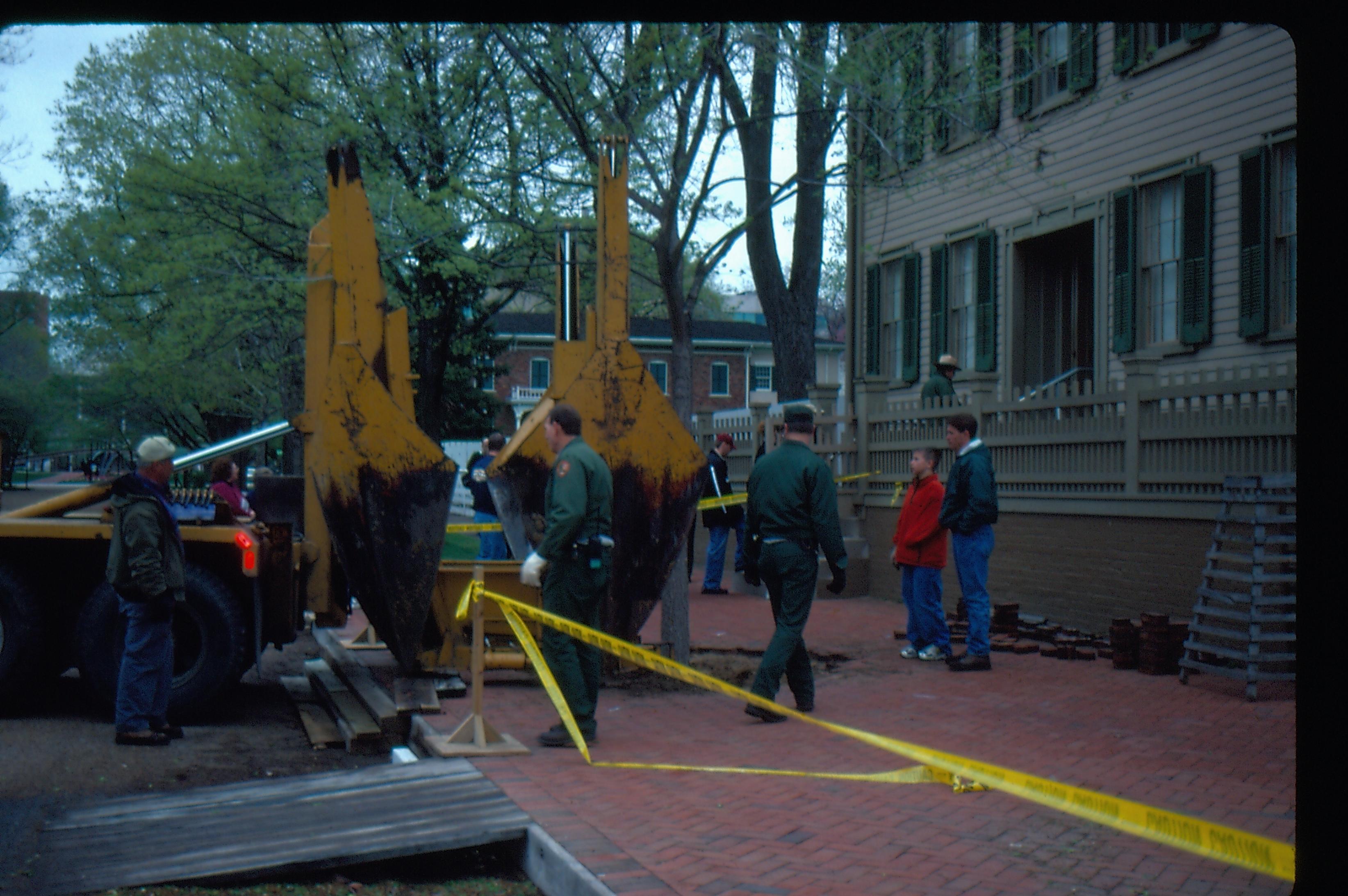 Elm tree removal - Pleasant Nursery staff beginning removal while City Arborist Mike Dirksen and son observe on right.  Maintenance workers Bob Trenter and Vee Pollack assist the crew.  Visitors start a tour of the Lincoln Home behind the equipment with Ranger ?. Conference Center in far background center. Looking Northeast from 8th and Jackson Street intersection Elm tree, Lincoln Home, brick plaza, Pleasant Nursery, staff, Arborist, visitors