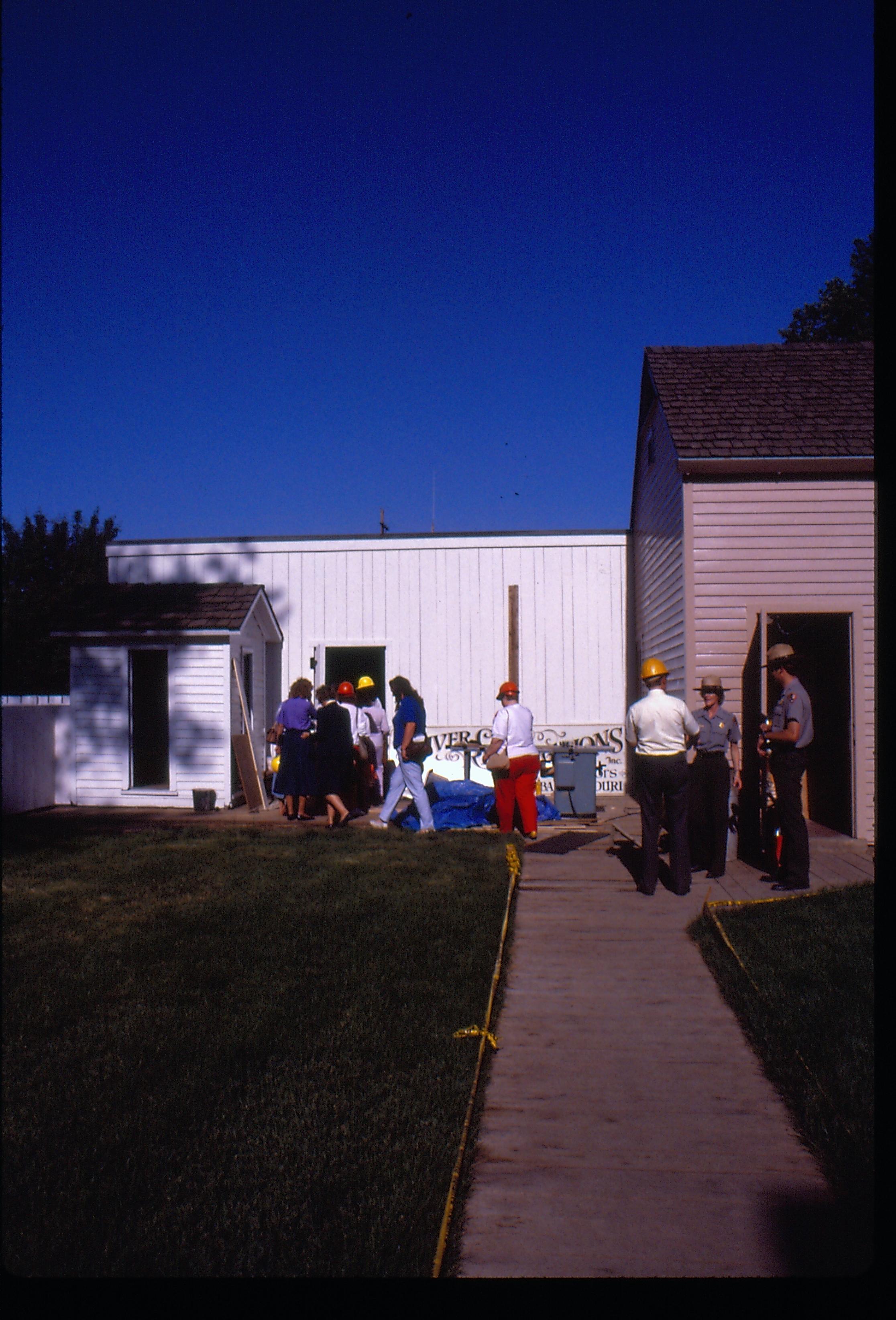 Members of the Colonial Dames on a tour entering the Carriage House in the back yard of the Lincoln Home during the 1987-88 Restoration of the Lincoln Home. Photographer facing east.