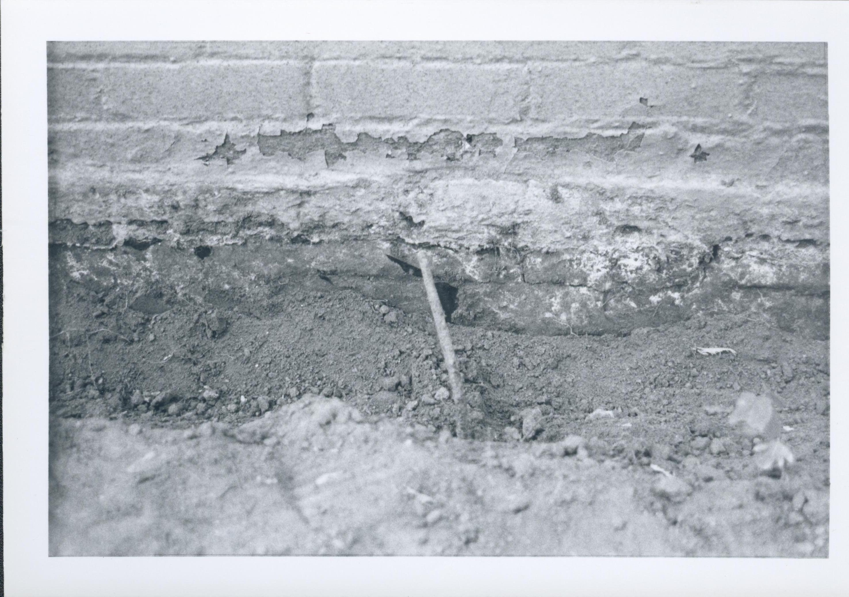 A large metal wire or bar jutting out from the Lincoln Home foundation. Uncovered during the 1987-1988 restoration.