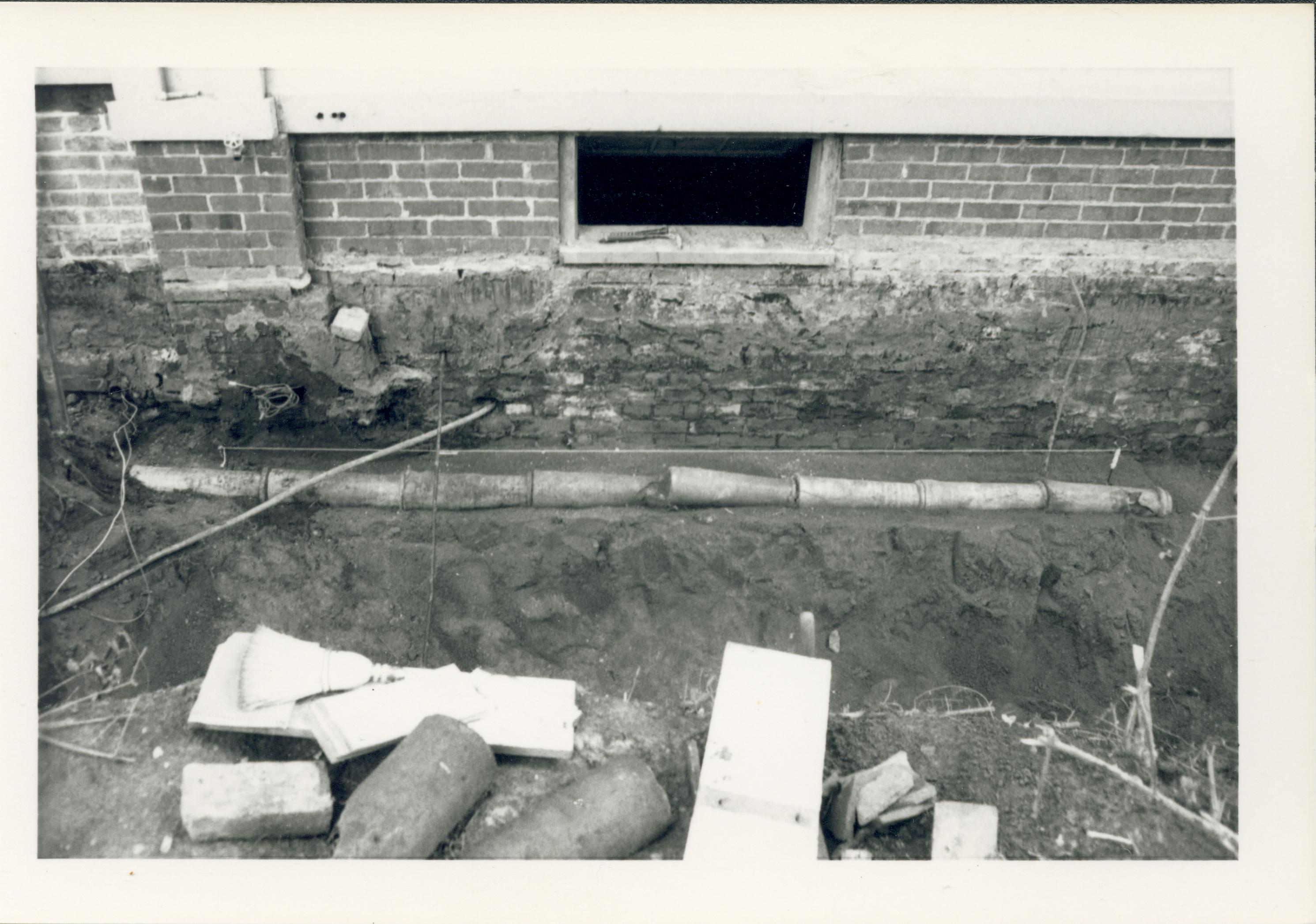 View of drain tiles along south west wall of Lincoln Home, before removal.