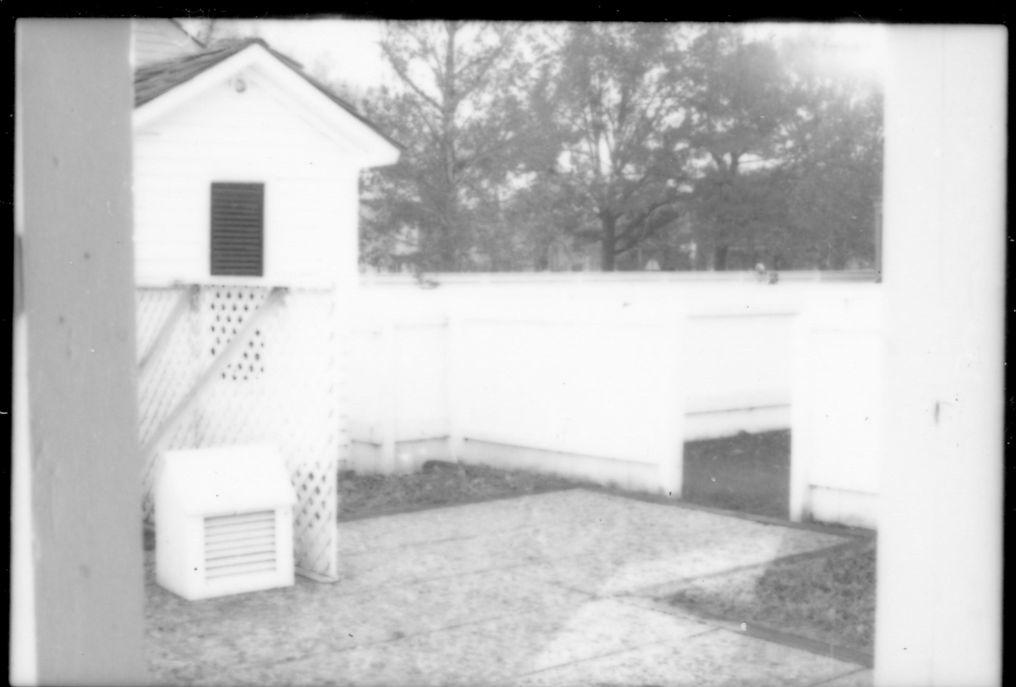 View of the B-2 concrete pad and Lincoln Home privy. Photographer under B-2 porch/roof, facing south west.