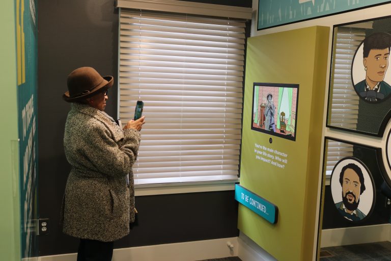 Community Leader, Kathryn Harris, tries out the "See yourself in Lincoln's Springfield" component.